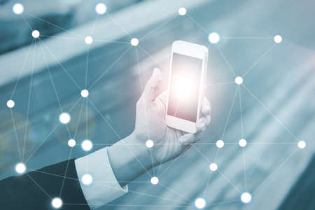 Businessman on blurred background using digital data network witの写真素材