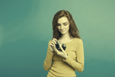 Close up Portrait young beautiful attractive ginger girl happy smiling with vintage camera and ready...