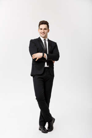Business Concept: Handsome Man Happy Smile Young Handsome Guy in smart suit posing over Isolated Grey Background.の写真素材