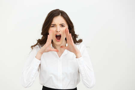 Business Concept: Closeup portrait of a businesswoman yelling isolated on white backgroundの写真素材