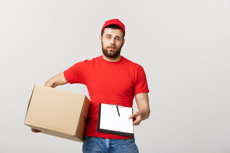 Delivery Concept: Young handsome delivery man with paper boxes giving you a document to sign