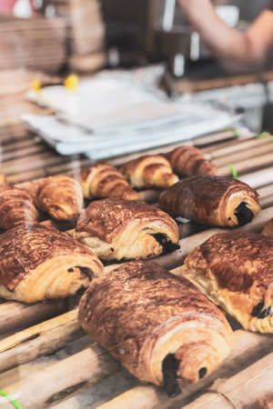 Freshly baked croissants on wooden board, top viewの写真素材