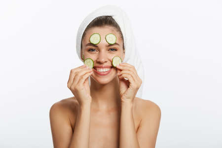 Smiling woman brushing her teeth with towel on her head. A great smileの写真素材