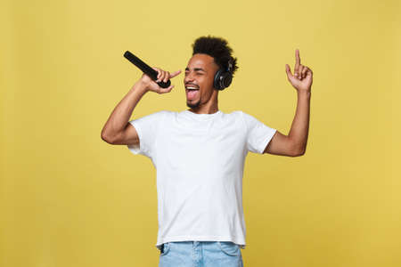 young handsome african american boy singing opera emotional with microphone.の写真素材