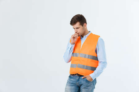 Thoughtful architect or engineer serious thinking against grey background.の写真素材