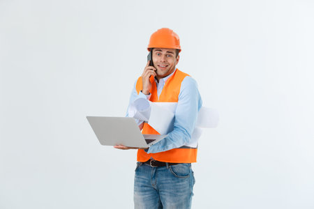 Young man wearing architect outfit and helmet with angry face, negative dislike emotion. Angry and...