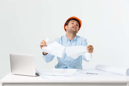 Crazy engineer or architect man with his project in his office. Angry Mood.の写真素材