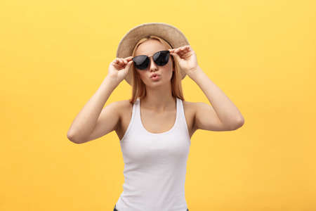 Close up Portrait young beautiful attractive blond girl smiling looking at camera. Isolated on yellow Pastel Background. Copy space.の写真素材