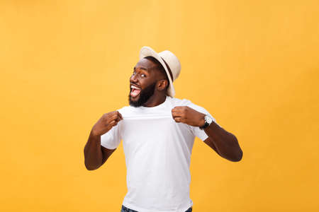 Handsome young Afro-American man employee feeling excited, gesturing actively, keeping fists clenched, exclaiming joyfully with mouth wide opened, happy with good luck or promotion at workの写真素材