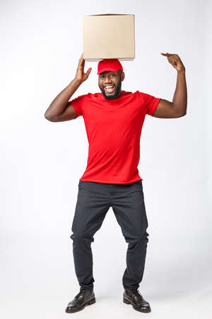 Happy African American man with a box on his headの写真素材