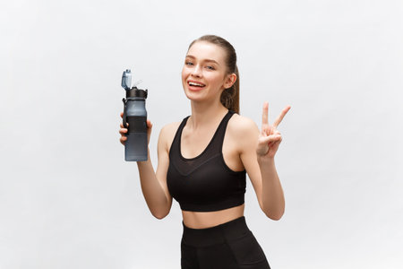 sport, fitness, lifestyle and people concept - happy sportive woman with water bottles.