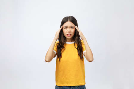 Young Asian woman got sick and headache isolated on white background.の写真素材