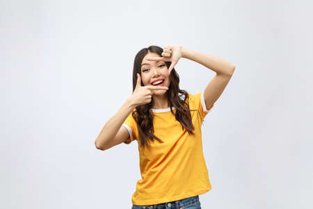 young asian woman hands making frame gesture on grey backgroundの写真素材