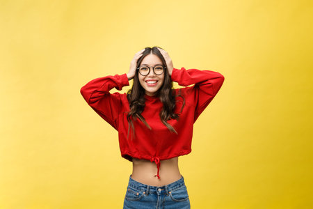 Portrait Happy Asian girl is surprised she is excited.Yellow background studio
