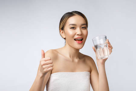 relaxed young smiling woman drinking clean water.の写真素材