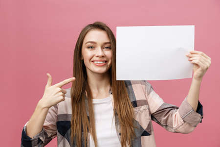 young smile woman standing pointing her finger at a blank board.の写真素材