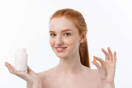 Beautiful Smiling Girl Taking Medication, Holding Bottle With Pills. Healthy Happy Female Eating Pill. Vitamins And Supplements,Diet Nutrition Conceptの写真素材