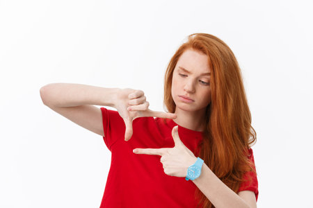 Happy woman making frame with fingers isolated on a white background.