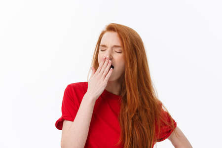 Young cute woman tired and very sleepy isolate over white background.の写真素材