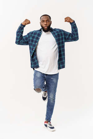 Healthy young black man jogging. Isolated over white background.の写真素材