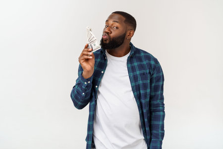 Happy african american young man holding dollars with white background.