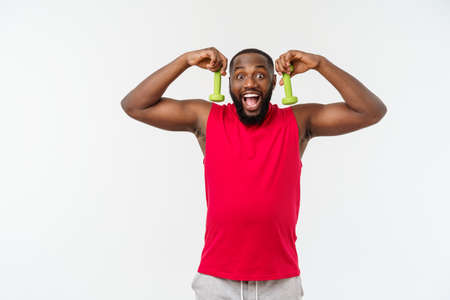 Young African American Athlete Holding Lifting Dumbbells on Isolated White Background.の写真素材