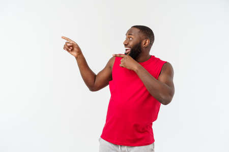 Young african american sport man pointing finger with surprised, feels successful and prosperousの写真素材