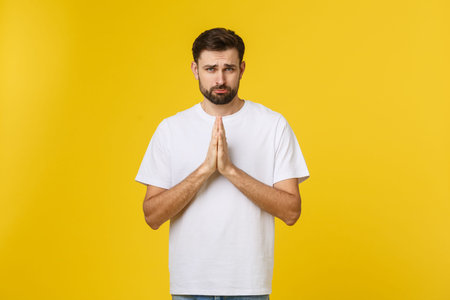 Calm and handsome. Portrait of handsome young man keeping hands clasped and looking thoughtful.