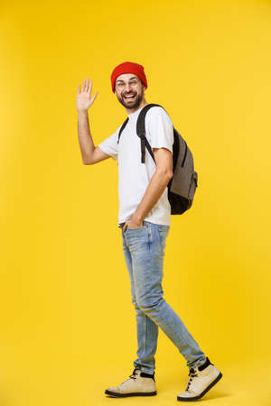 young hipster man wearing hat , suspenders, isolate on yellow background.の写真素材