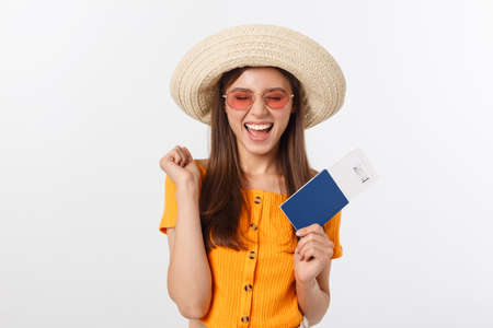 Portrait of happy tourist woman holding passport on holiday on white background.の写真素材