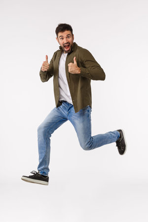 Sounds nice. Full-length vertical studio shot cheerful triumphing caucasian bearded man in street...
