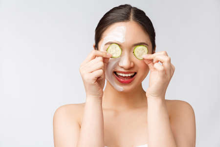 Beauty young asian women skin care image with cucumber on white background studioの写真素材