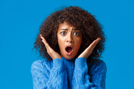 Close-up panicking, troubled and shocked african-american woman with curly afro haircut, gasping...