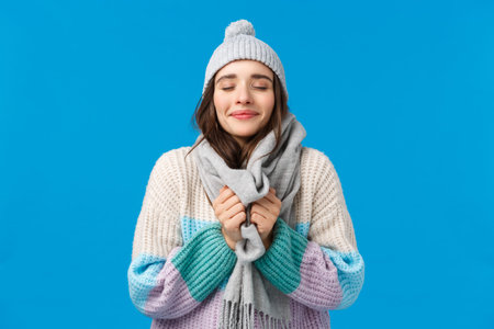 Happiness, dreams and christmas mood concept. Cheerful attractive sensual young woman in winter hat,...