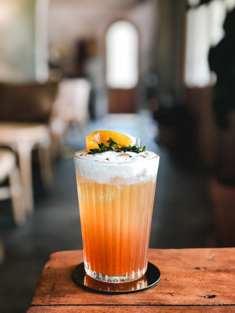 Peach tea with cream cheese in modern cafe