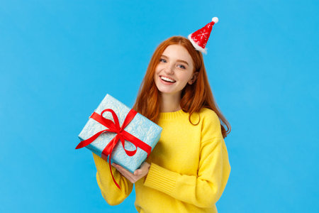 Holidays, celebration and presents concept. Cheerful redhead girl love christmas, enjoy celebrating...