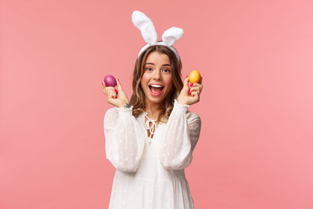 Holidays, spring and party concept. Portrait of excited charming young woman celebrating Easter in...