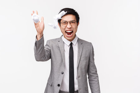 Waist-up portrait of distressed, stressed and angry young asian male manager, office worker destroy...