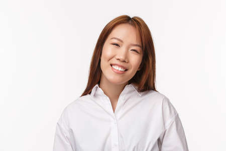 Close-up portrait of woman with pleasant friendly-looking expression, office lady or manager meeting client trying help and solve problem as working company, standing white backgroundの写真素材