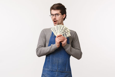 Small business, finance and career concept. Enthusiastic young male student working part-time at...