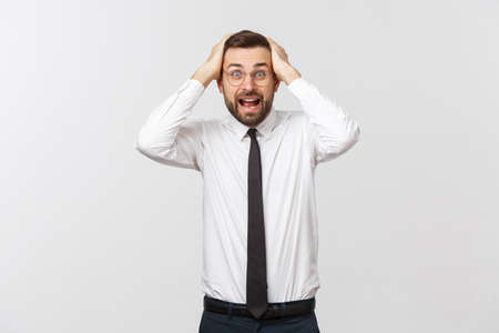 A view of a shocked young businessman isolated on white backgroundの写真素材
