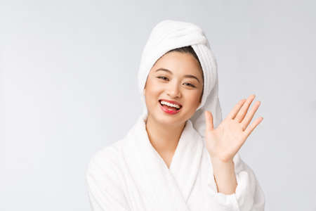 Spa skincare beauty Asian woman drying hair with towel on head after shower treatment. Beautiful multiracial young girl touching soft skinの写真素材