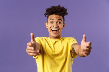 Close-up portrait of charismatic, happy friendly-looking hispanic man with dreads reaching hands...