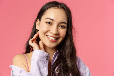 Close-up portrait of tender, beautiful young asian woman with clean skin, no pimples or blemishes,...