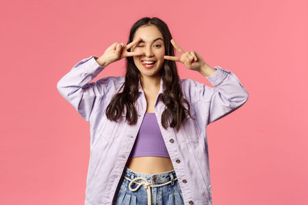 Love and peace people. Cheerful carefree attractive girl sending positivity and happiness, show...