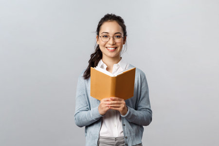 Education, teachers, university and schools concept. Young smart and creative asian female student...
