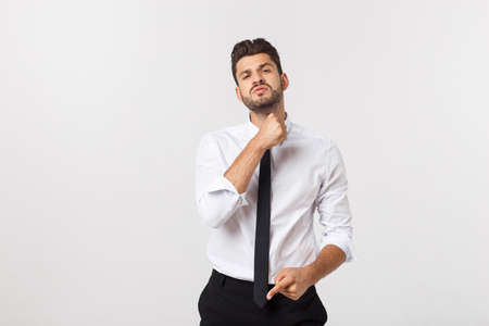 Portrait of a confident businessman in business cloth, fixing his tie.の写真素材