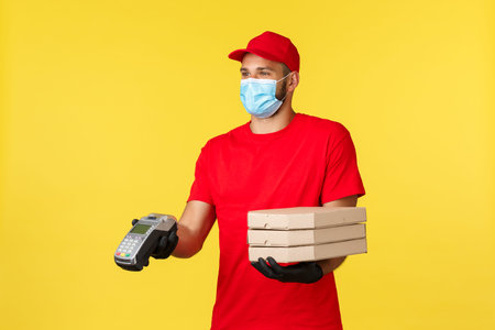 Food delivery, tracking orders, covid-19 and self-quarantine concept. Smiling friendly courier in...