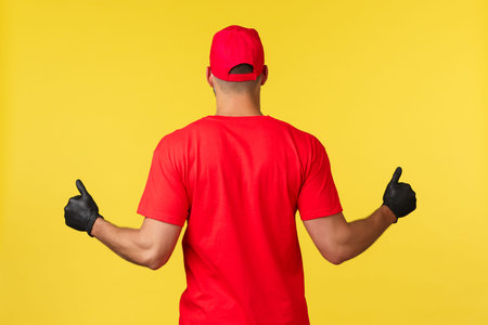 Orders during pandemic, covid-19, safe shipping, online shopping concept. Back of strong masculine...