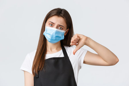 Covid-19 social distancing, cafe employees, coffee shops and coronavirus concept. Upset and...